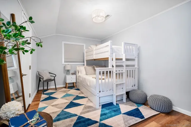 a bedroom with furniture and a rug