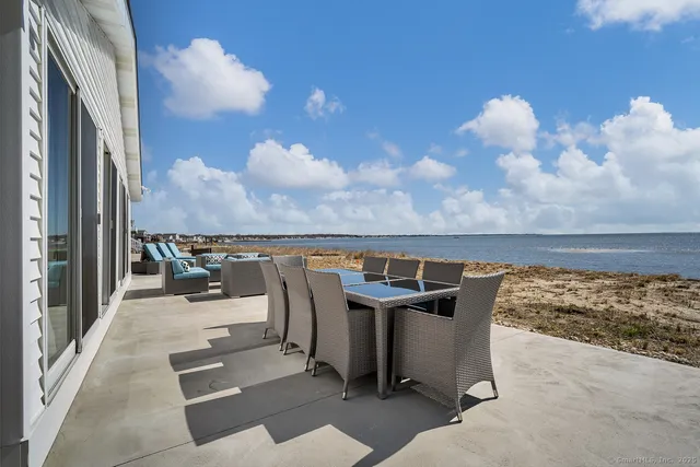 a roof deck with table and chairs