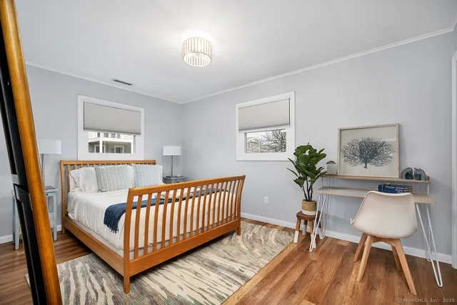 a view of a bedroom with furniture and wooden floor