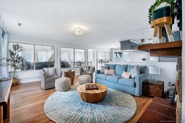 a living room with furniture a dining table and a chandelier