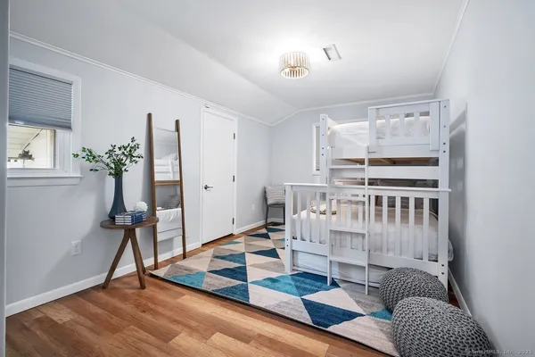 a bedroom with furniture and a rug