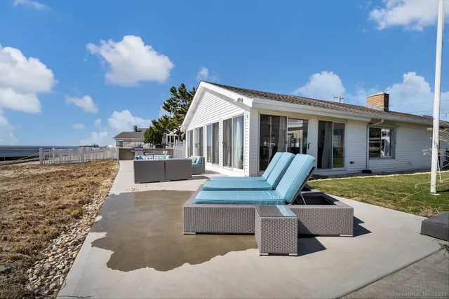 a view of a house with backyard porch and sitting area