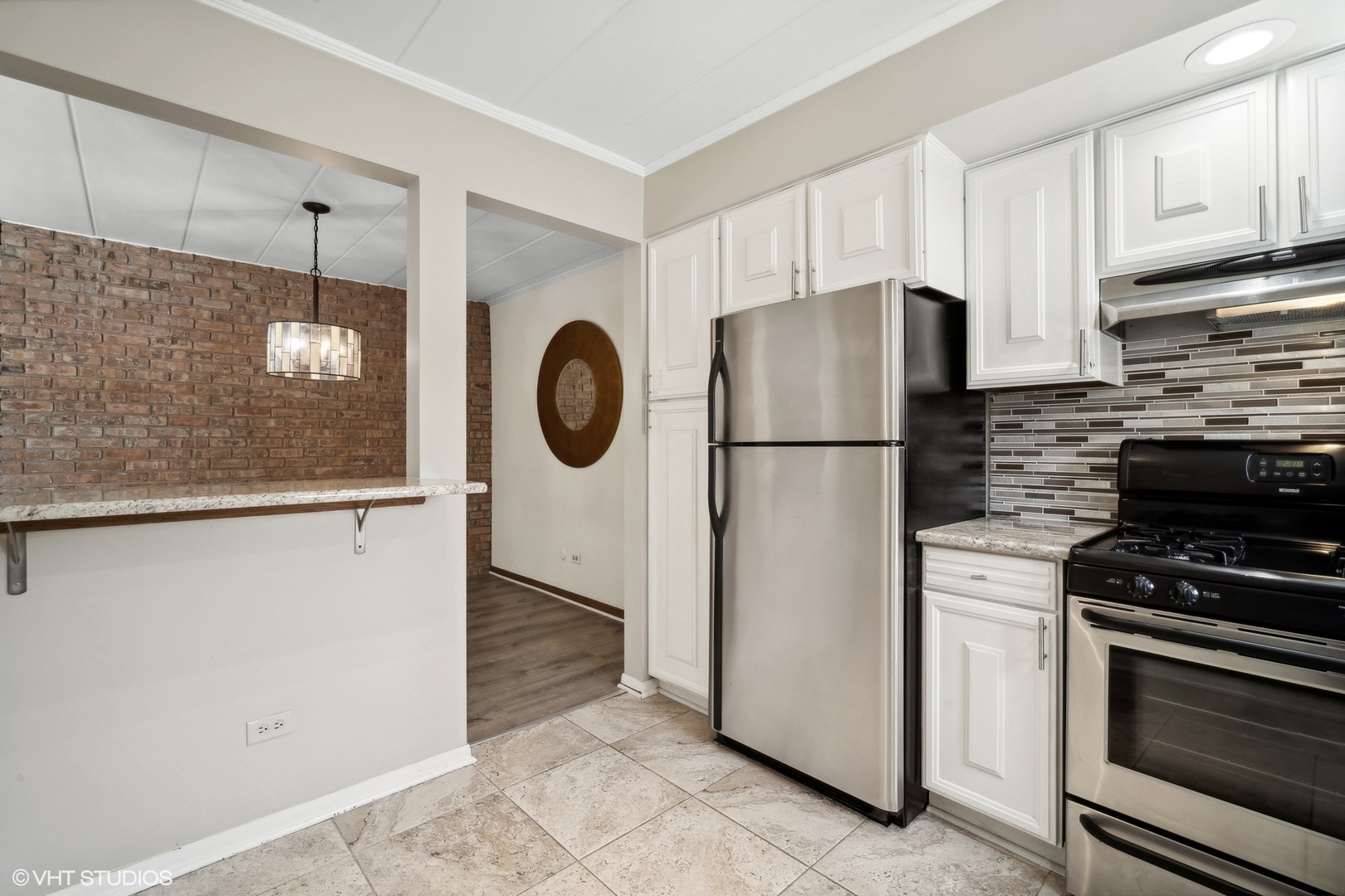 2 North Dee Road, Unit 103 Park Ridge, IL 60068 - Photo 17 of 30 a kitchen with a refrigerator a stove and cabinets