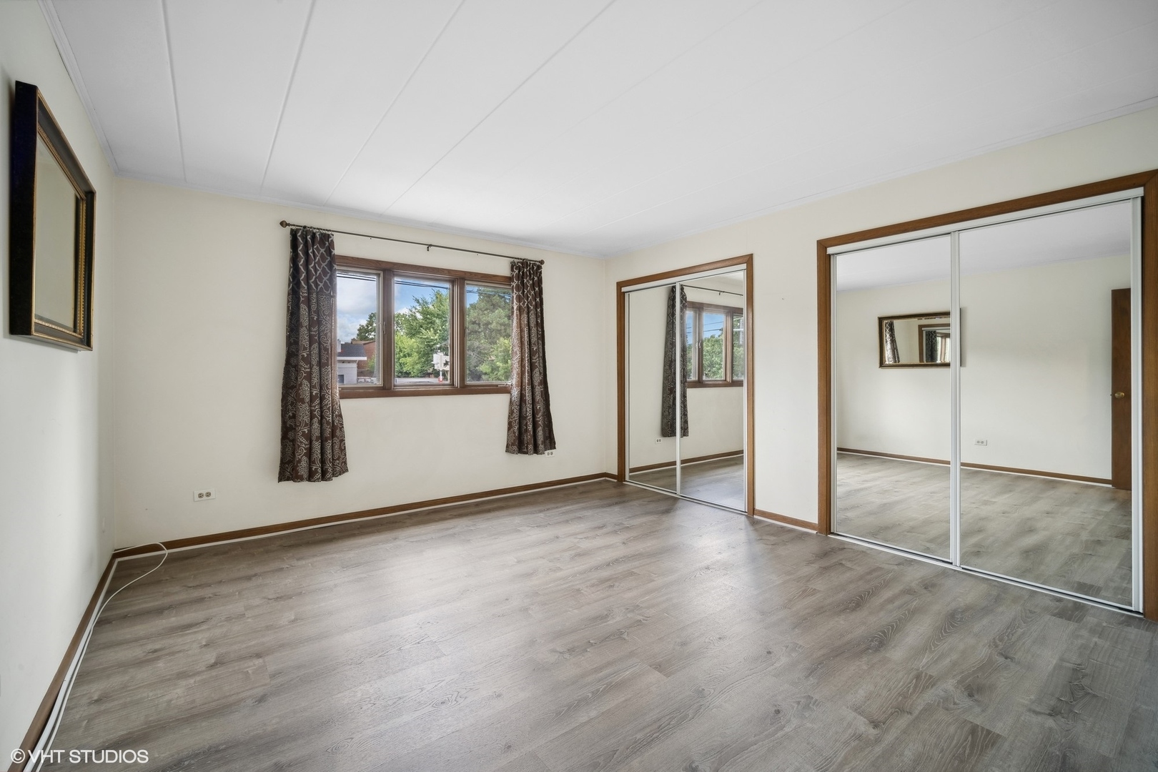 2 North Dee Road, Unit 103 Park Ridge, IL 60068 - Photo 19 of 30 an empty room with wooden floor and windows