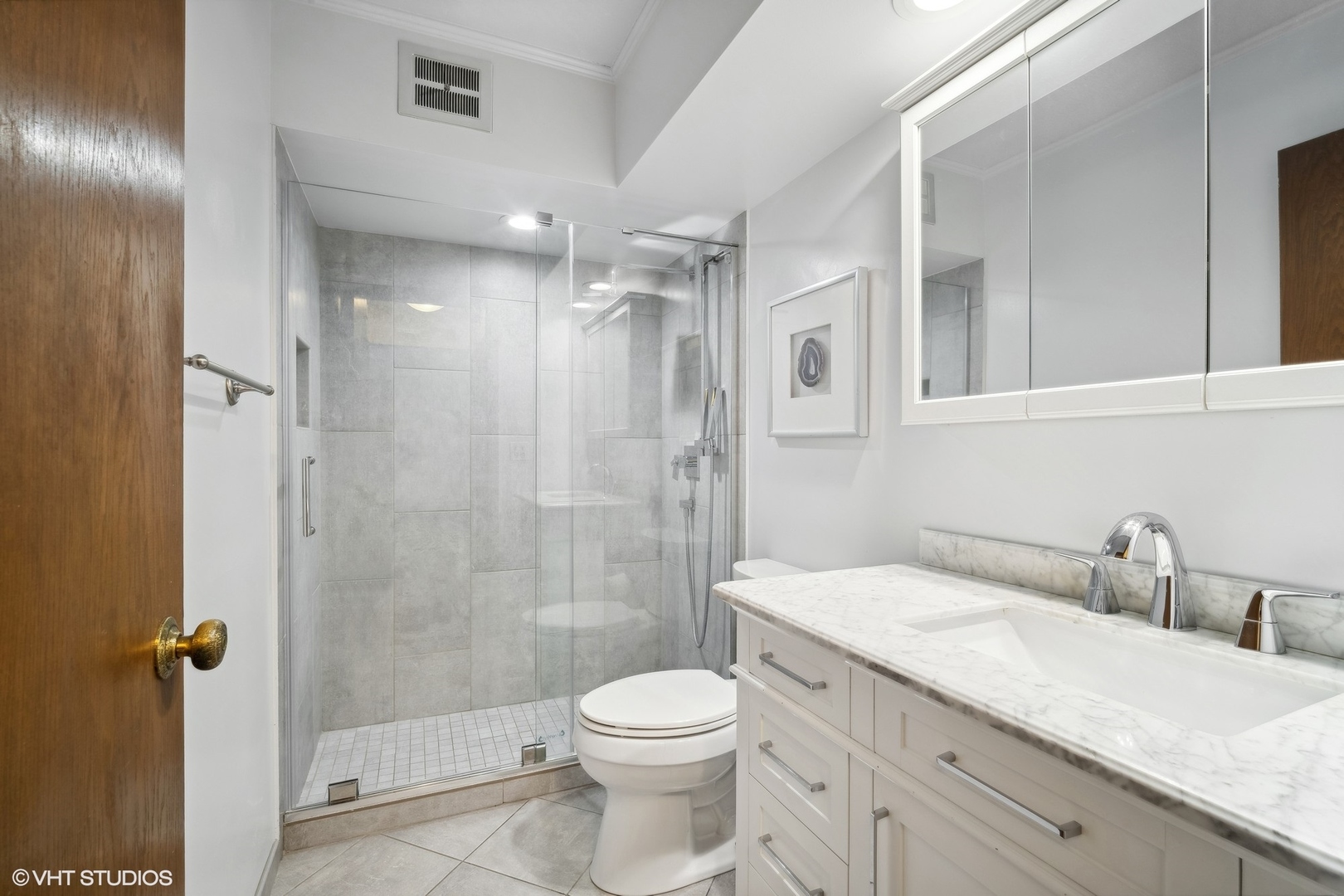 2 North Dee Road, Unit 103 Park Ridge, IL 60068 - Photo 21 of 30 a bathroom with a granite countertop sink a toilet and shower