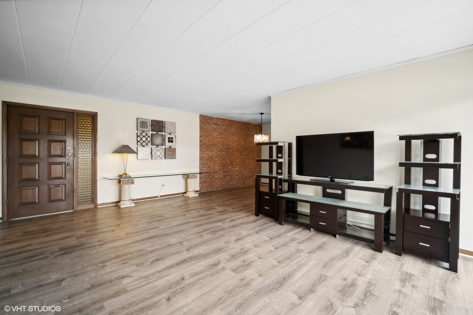 2 North Dee Road, Unit 103 Park Ridge, IL 60068 - Photo 6 of 30 a living room with furniture and flat screen tv