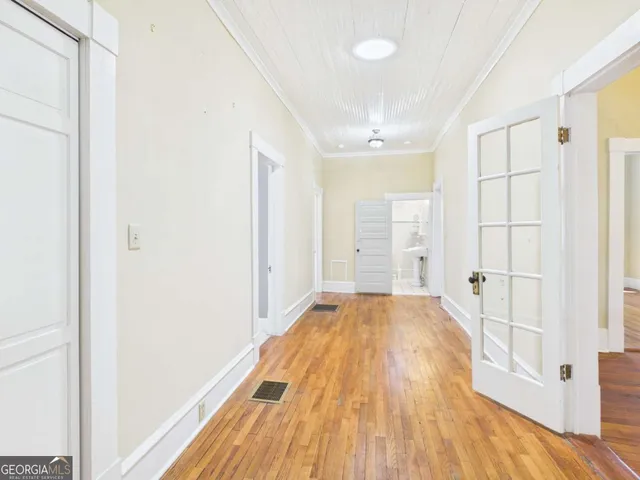 a view of a room with wooden floor and natural light