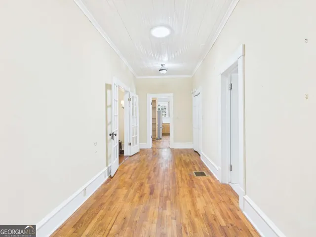 a view of a room with wooden floor