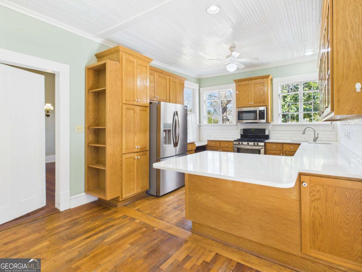 20 Simonton Bridge Road Watkinsville, GA 30677 - Photo 20 of 47 a kitchen with stainless steel appliances granite countertop a refrigerator a stove and a sink with couches