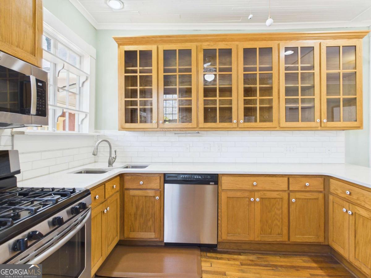 20 Simonton Bridge Road Watkinsville, GA 30677 - Photo 23 of 47 a kitchen with a sink stove and cabinets
