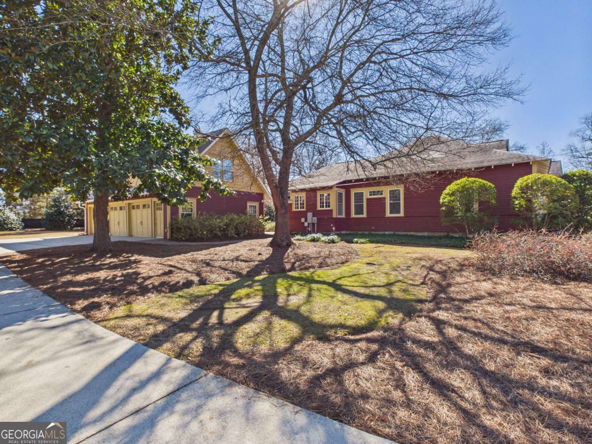 20 Simonton Bridge Road Watkinsville, GA 30677 - Photo 36 of 47 a view of swimming pool with large trees and wooden fence