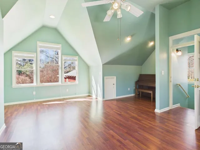 a kitchen with granite countertop stainless steel appliances a refrigerator cabinets and wooden floor