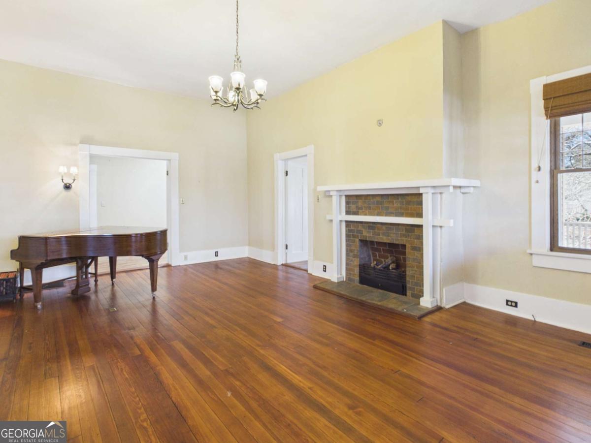 20 Simonton Bridge Road Watkinsville, GA 30677 - Photo 4 of 47 a view of a livingroom with furniture wooden floor a fireplace and windows