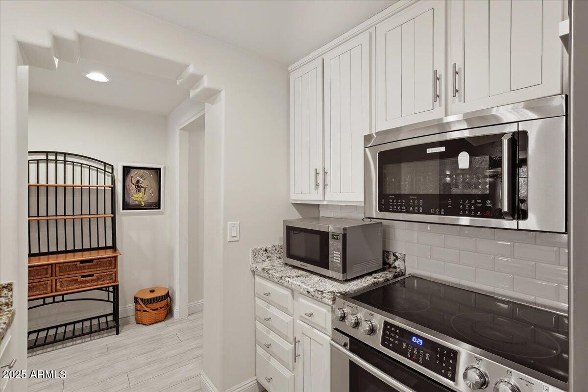 36601 North Mule Train Road, Unit B20 Carefree, AZ 85377 - Photo 13 of 27 a kitchen with granite countertop a stove and a microwave