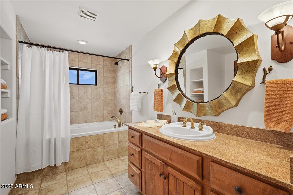 36601 North Mule Train Road, Unit B20 Carefree, AZ 85377 - Photo 15 of 27 a bathroom with a granite countertop sink a mirror and a bathtub