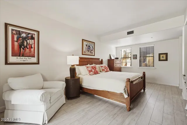 a spacious bedroom with a bed and a couch