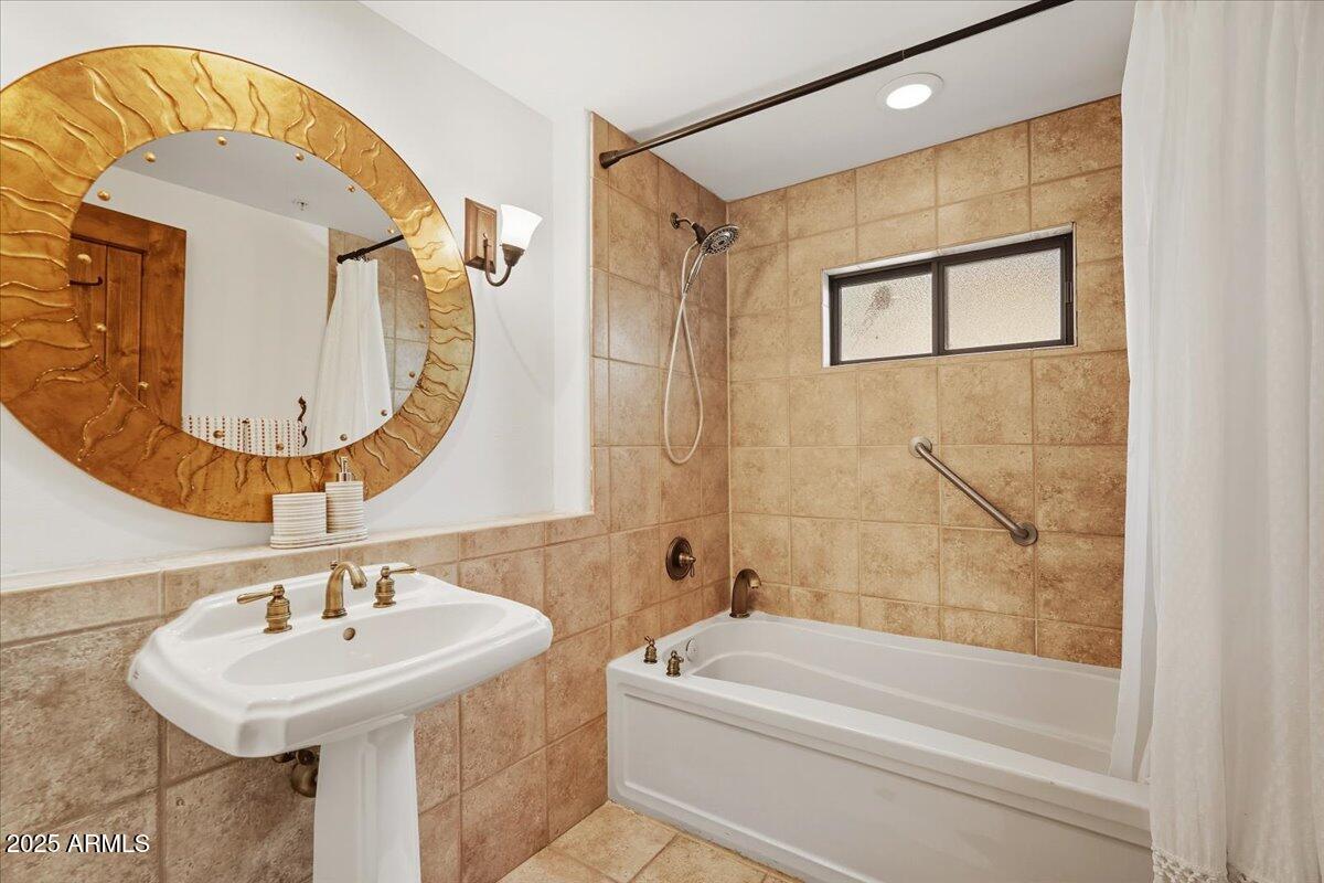 36601 North Mule Train Road, Unit B20 Carefree, AZ 85377 - Photo 19 of 27 a bathroom with a sink a mirror and a bathtub