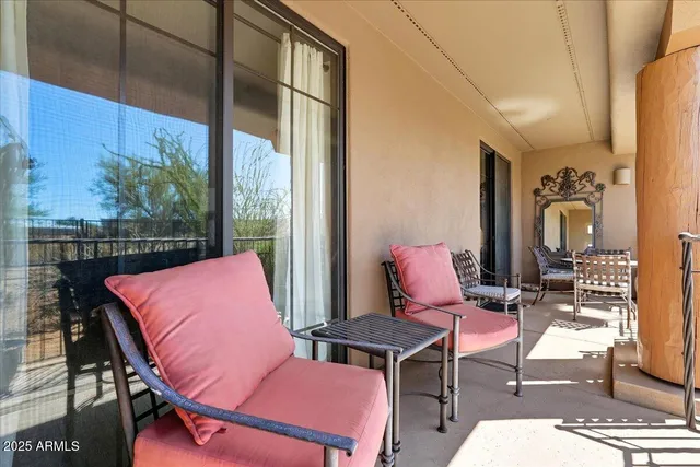 a outdoor sitting area with furniture and wooden floor