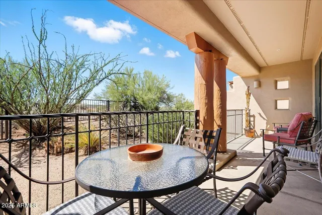 a outdoor dining space with furniture and umbrella