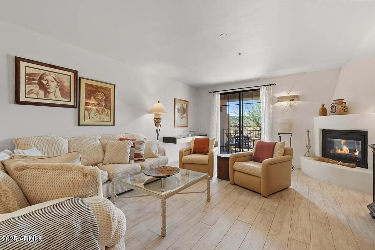 36601 North Mule Train Road, Unit B20 Carefree, AZ 85377 - Photo 4 of 27 a living room with furniture and a fireplace