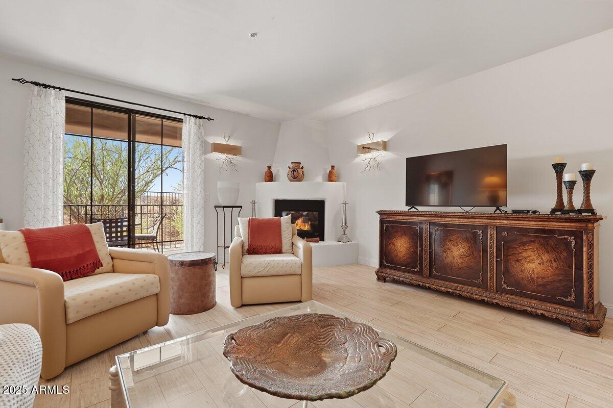 36601 North Mule Train Road, Unit B20 Carefree, AZ 85377 - Photo 7 of 27 a living room with furniture a flat screen tv and a fireplace
