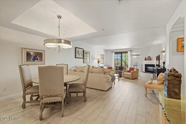 a living room with furniture and a chandelier