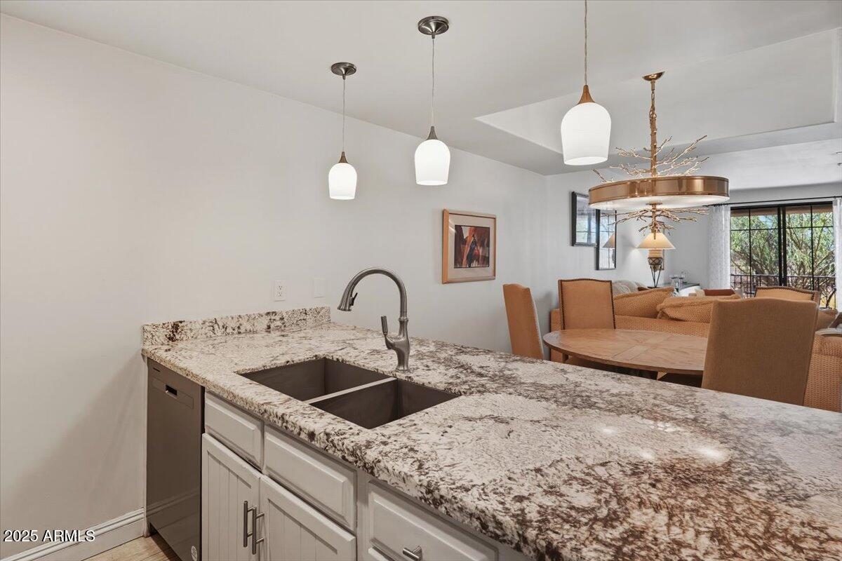 36601 North Mule Train Road, Unit B20 Carefree, AZ 85377 - Photo 10 of 27 a kitchen with stainless steel appliances granite countertop a sink a stove and a wooden floors