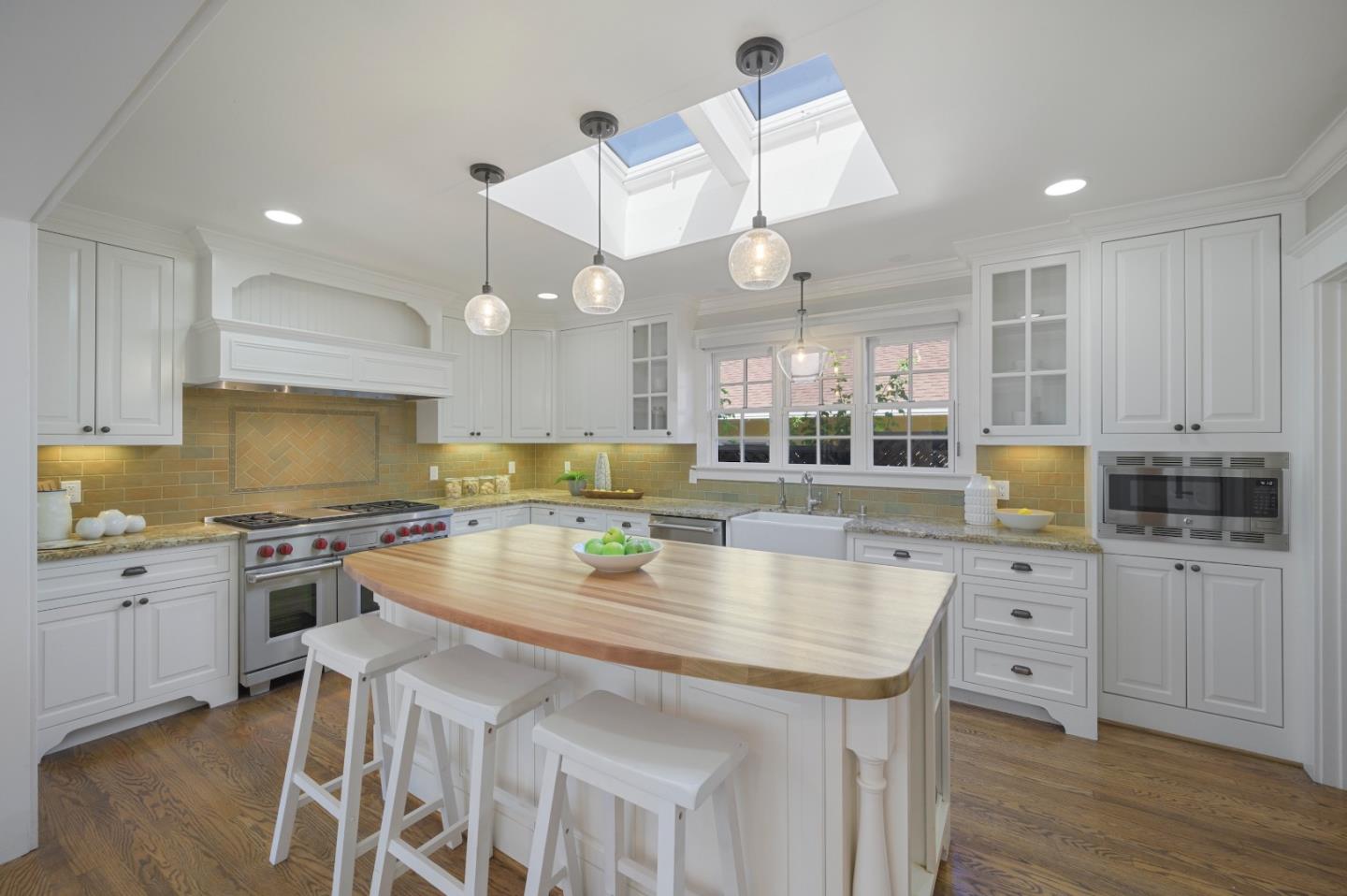 343 Warren Road San Mateo, CA 94402 - Photo 11 of 28 a kitchen with a stove center island cabinets and wooden floor