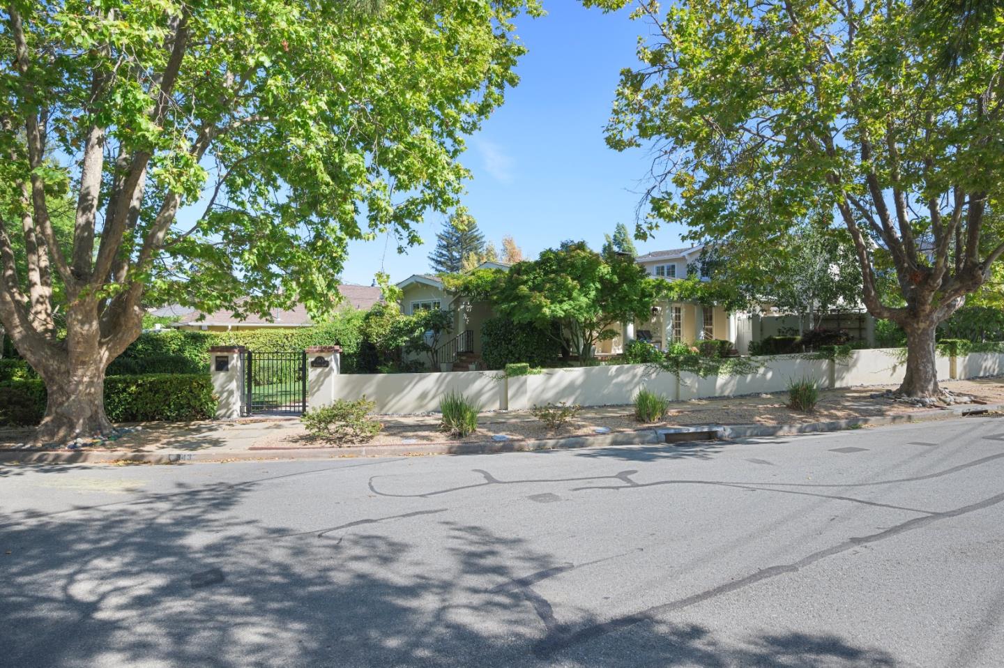 343 Warren Road San Mateo, CA 94402 - Photo 26 of 28 a backyard of a house with table and chairs under an umbrella