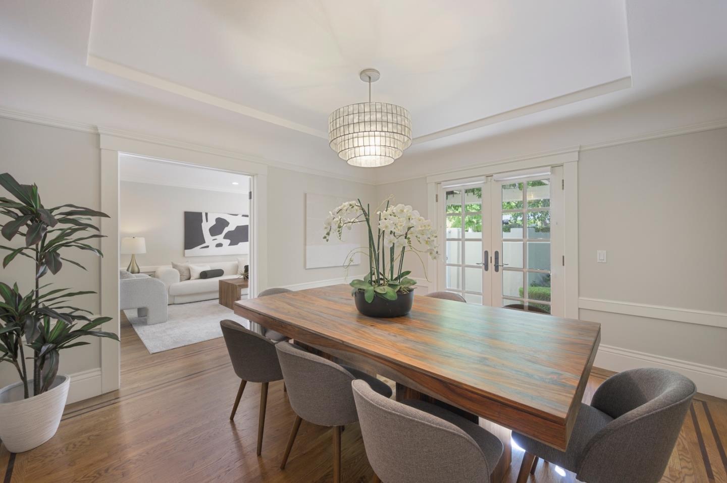 343 Warren Road San Mateo, CA 94402 - Photo 9 of 28 a dining room with furniture potted plants and wooden floor