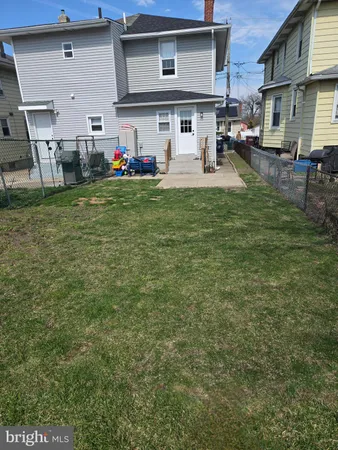 a front view of a house with a yard and sitting area