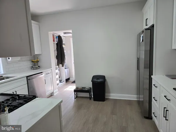 a kitchen with a refrigerator and a stove