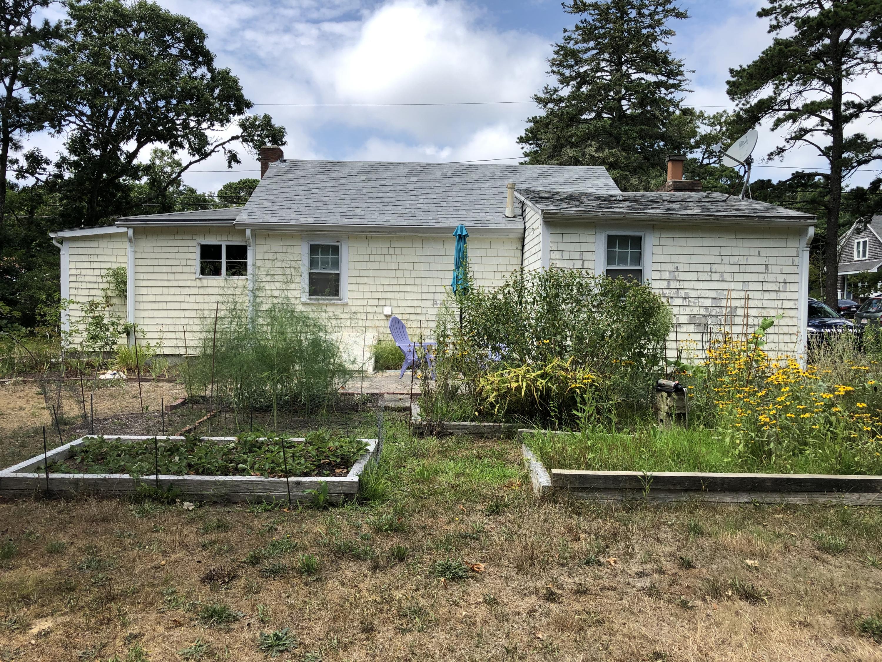 23 Kendrick Road Harwich, MA 02645 - Photo 3 of 13 a front view of a house with garden