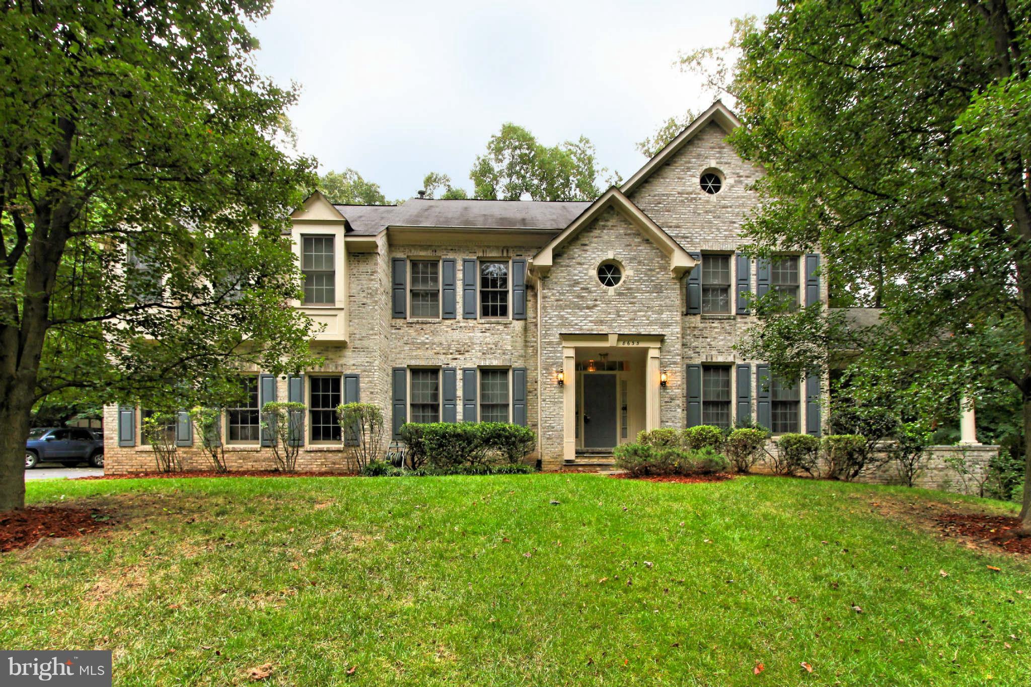 8635 Tuttle Road, Unit 2 Springfield, VA 22152 - Photo 1 of 30 a front view of a house with a yard
