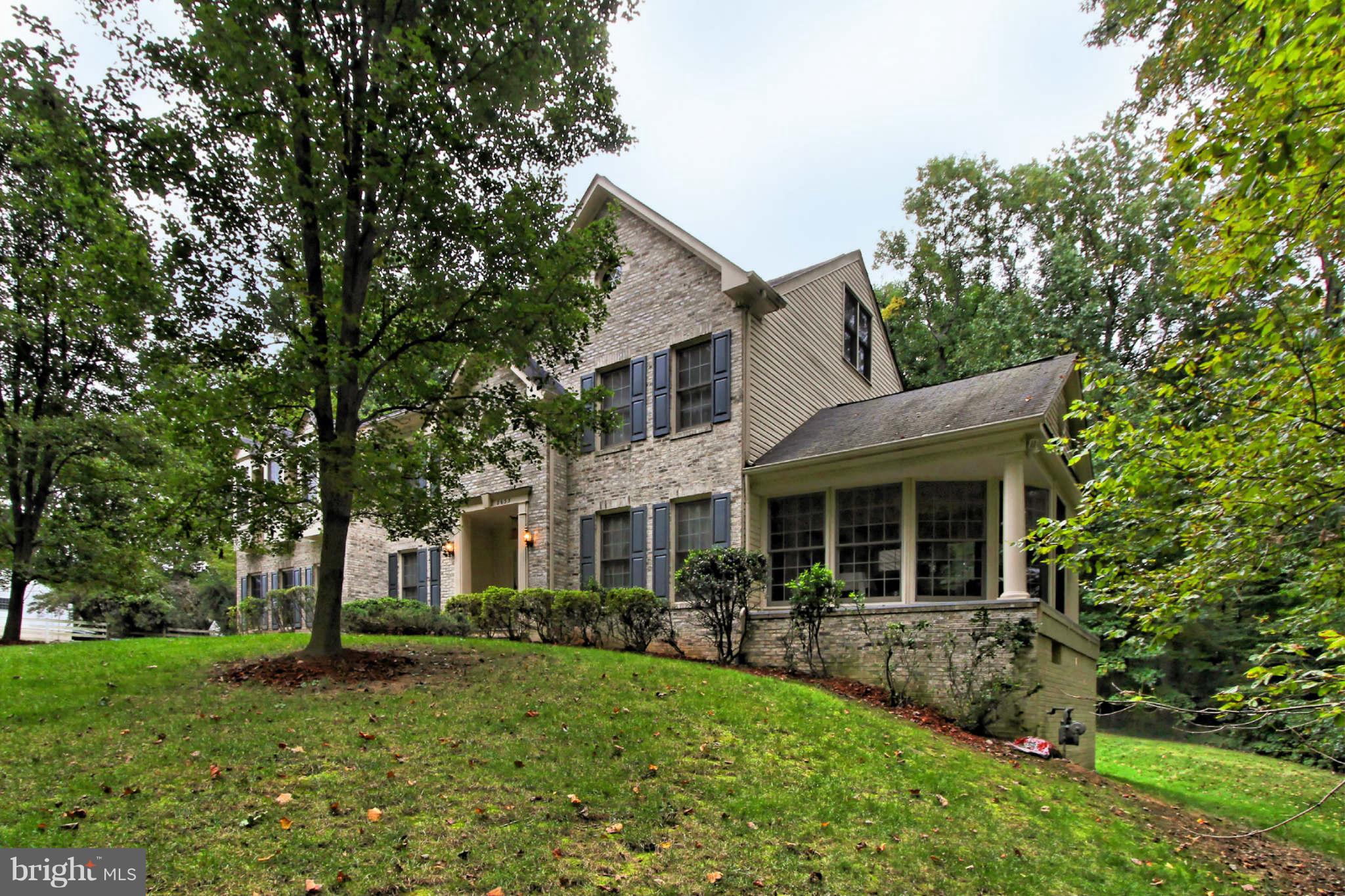 8635 Tuttle Road, Unit 2 Springfield, VA 22152 - Photo 2 of 30 a front view of a house with porch and garden