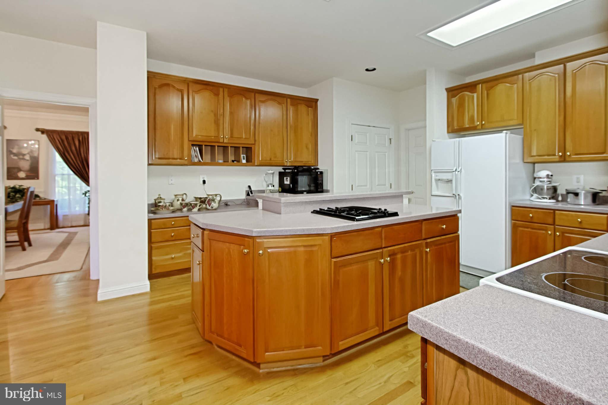 8635 Tuttle Road, Unit 2 Springfield, VA 22152 - Photo 12 of 30 a kitchen with stainless steel appliances granite countertop a sink a stove a refrigerator cabinets and wooden floor