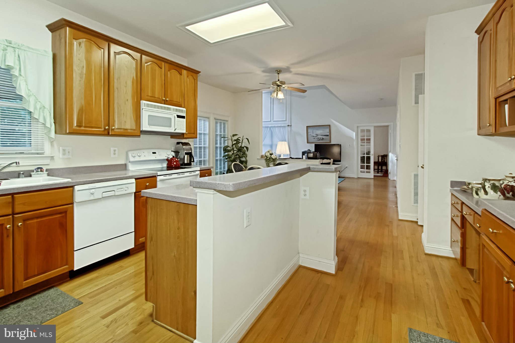 8635 Tuttle Road, Unit 2 Springfield, VA 22152 - Photo 13 of 30 a kitchen with a sink appliances cabinets and a large window