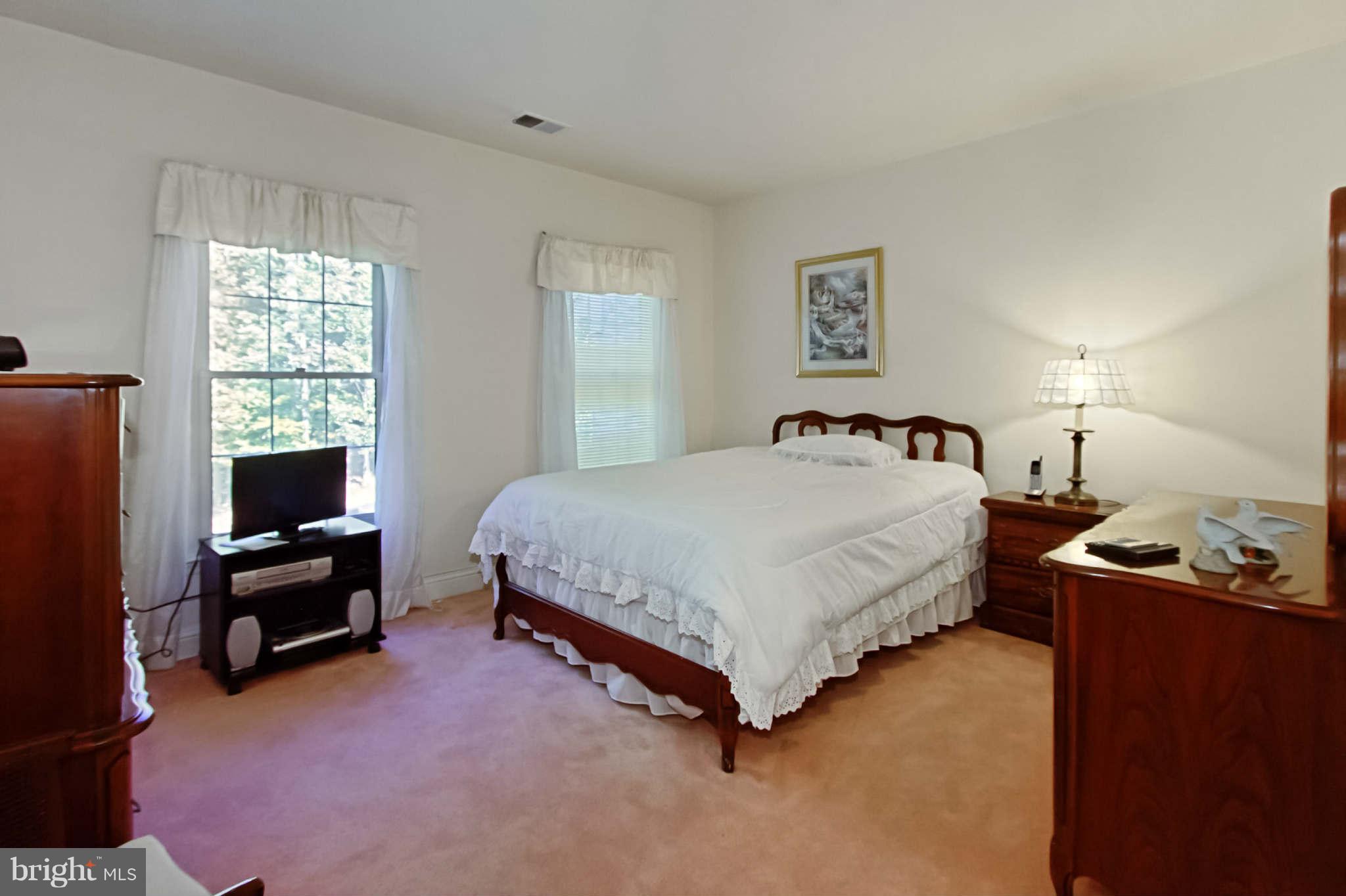 8635 Tuttle Road, Unit 2 Springfield, VA 22152 - Photo 19 of 30 a bedroom with a bed and dresser with window