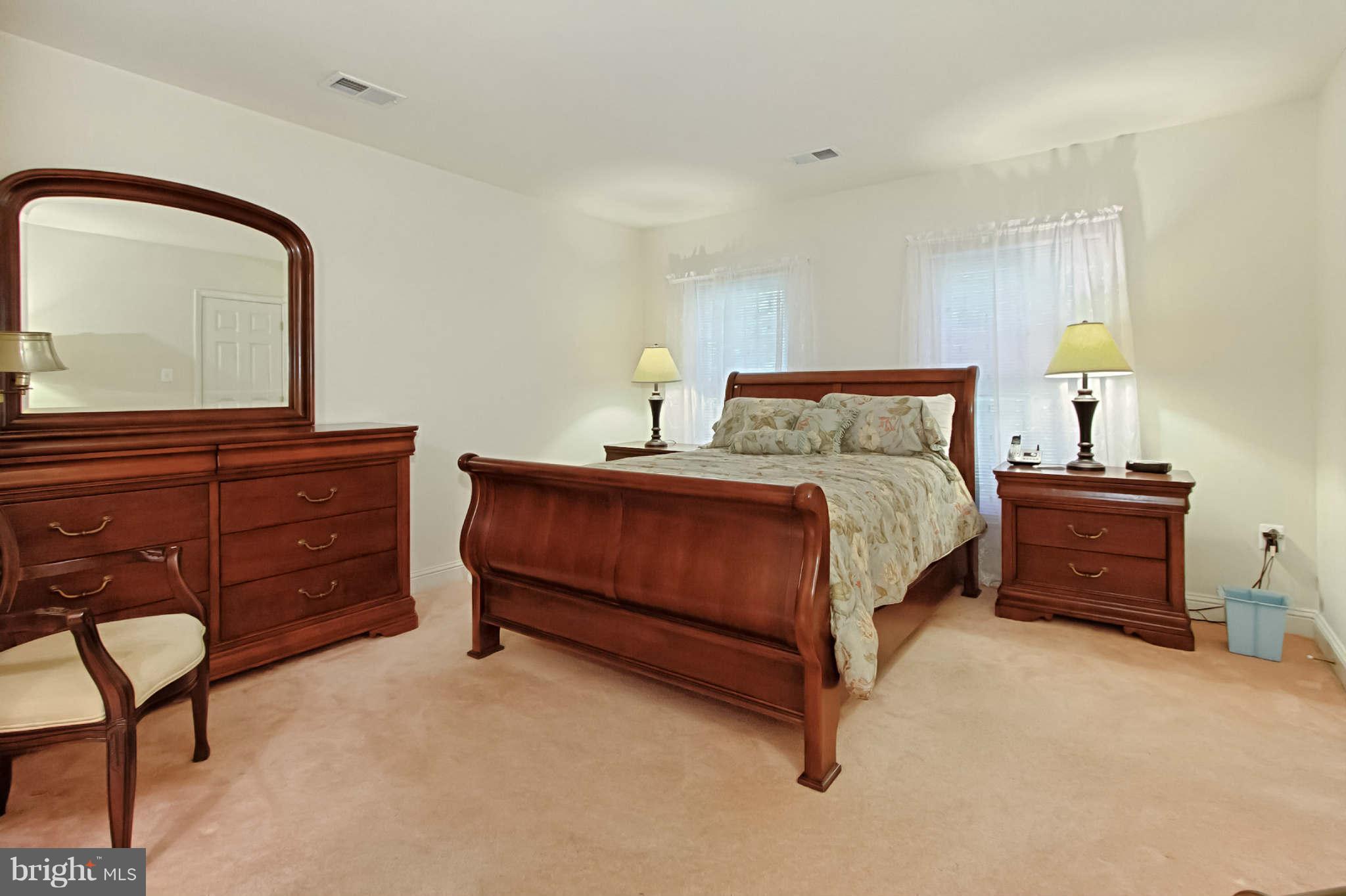 8635 Tuttle Road, Unit 2 Springfield, VA 22152 - Photo 21 of 30 a bedroom with a bed and a dresser