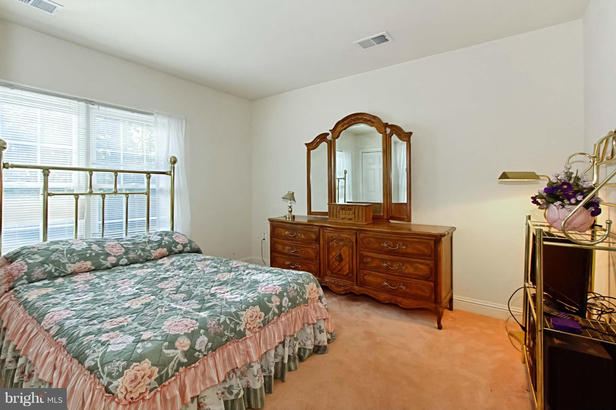 8635 Tuttle Road, Unit 2 Springfield, VA 22152 - Photo 23 of 30 a bedroom with a bed and a flat screen tv