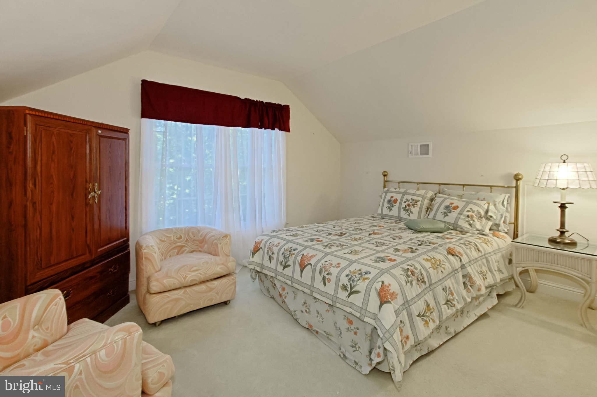 8635 Tuttle Road, Unit 2 Springfield, VA 22152 - Photo 25 of 30 a bedroom with a bed and a couch