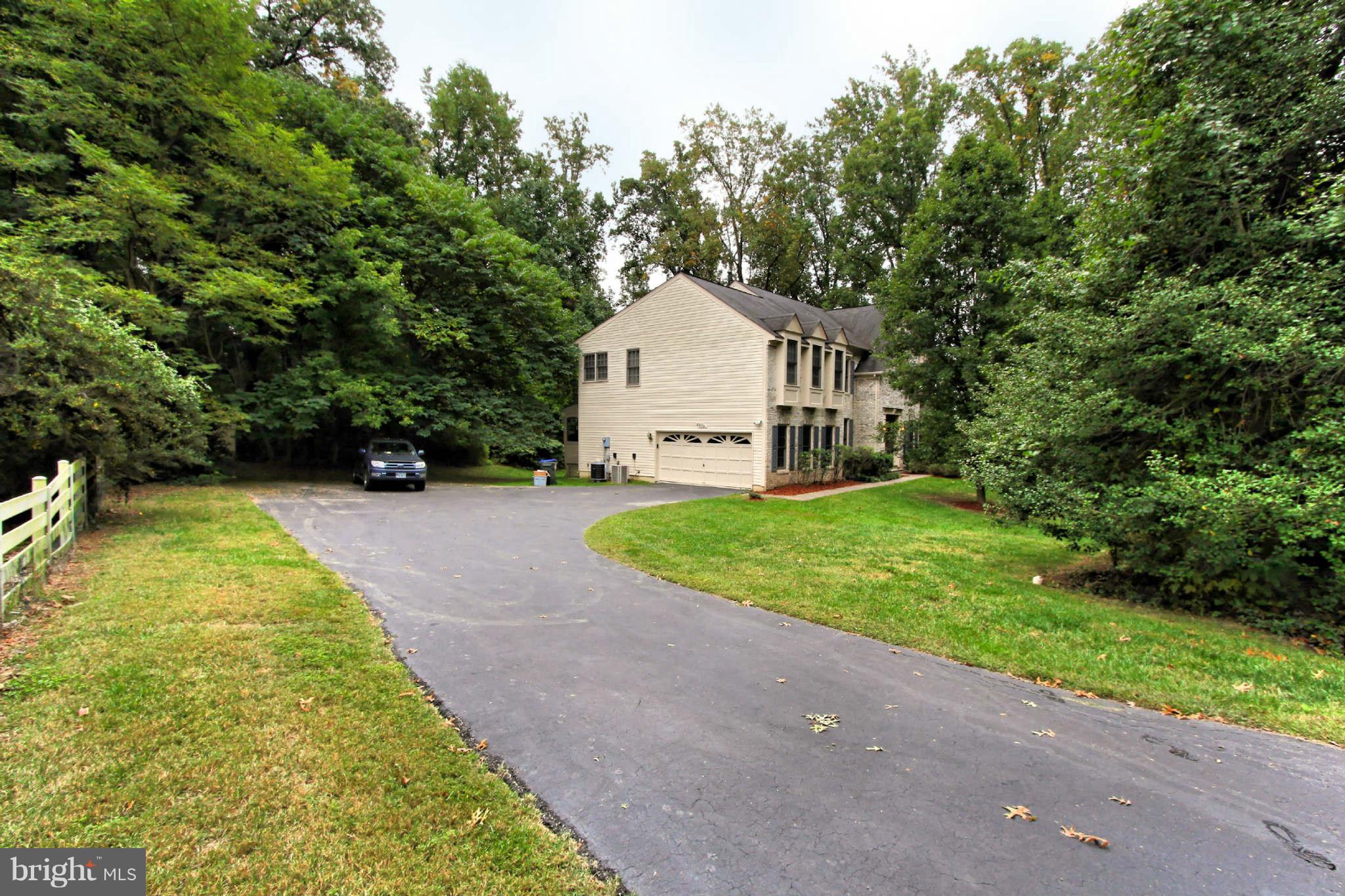 8635 Tuttle Road, Unit 2 Springfield, VA 22152 - Photo 30 of 30 a view of a house with a yard and large trees