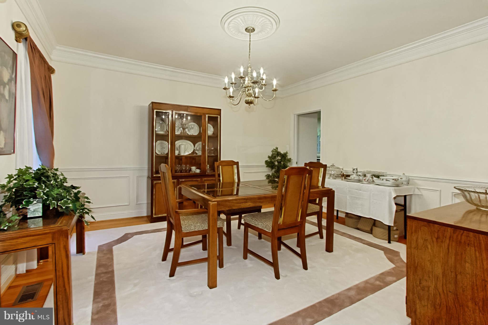 8635 Tuttle Road, Unit 2 Springfield, VA 22152 - Photo 6 of 30 a view of a dining room with furniture and chandelier
