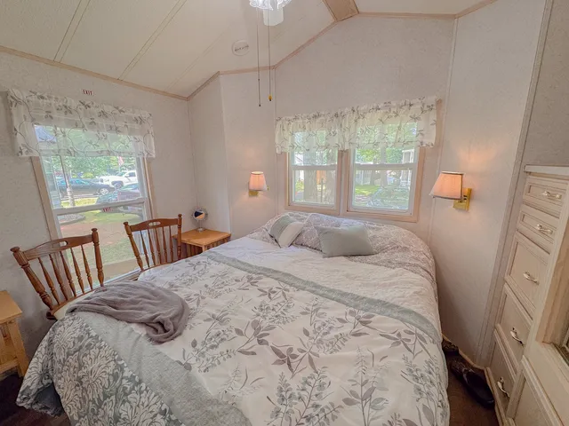 a bedroom with a bed next to a window