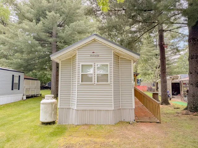 a view of a patio with wooden fence and a fire pit