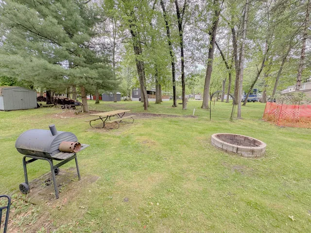 a garden with trees and a wooden fence
