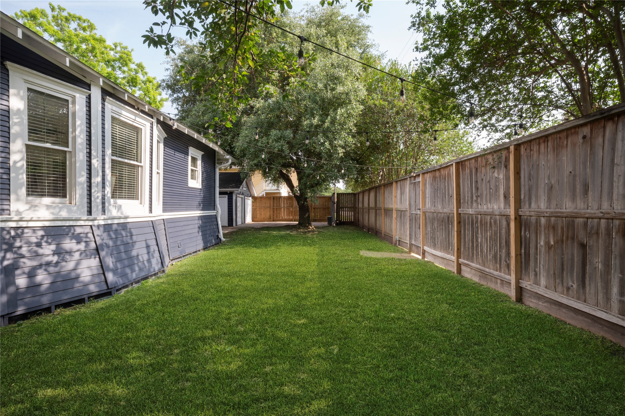 602 Aurora Street Houston, TX 77008 - Photo 2 of 36 Backyard with a wide stretch of lawn and room for outdoor use. Fully fenced with space to relax, entertain, or expand on landscaping. A clean outdoor setting that complements the home’s overall layout.