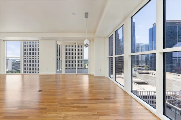 a view of an empty room with wooden floor