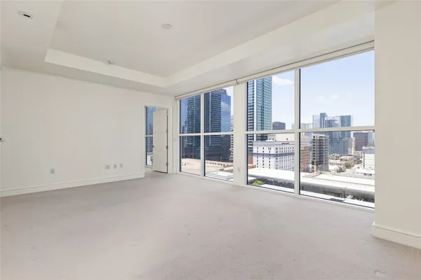 a spacious bathroom with a granite countertop sink mirror and a bathtub