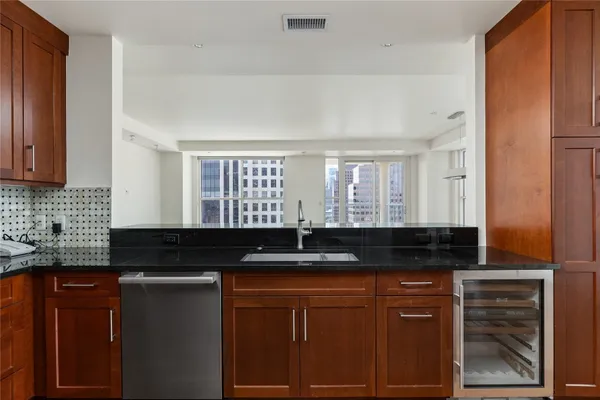 a kitchen with granite countertop stainless steel appliances and wooden cabinets